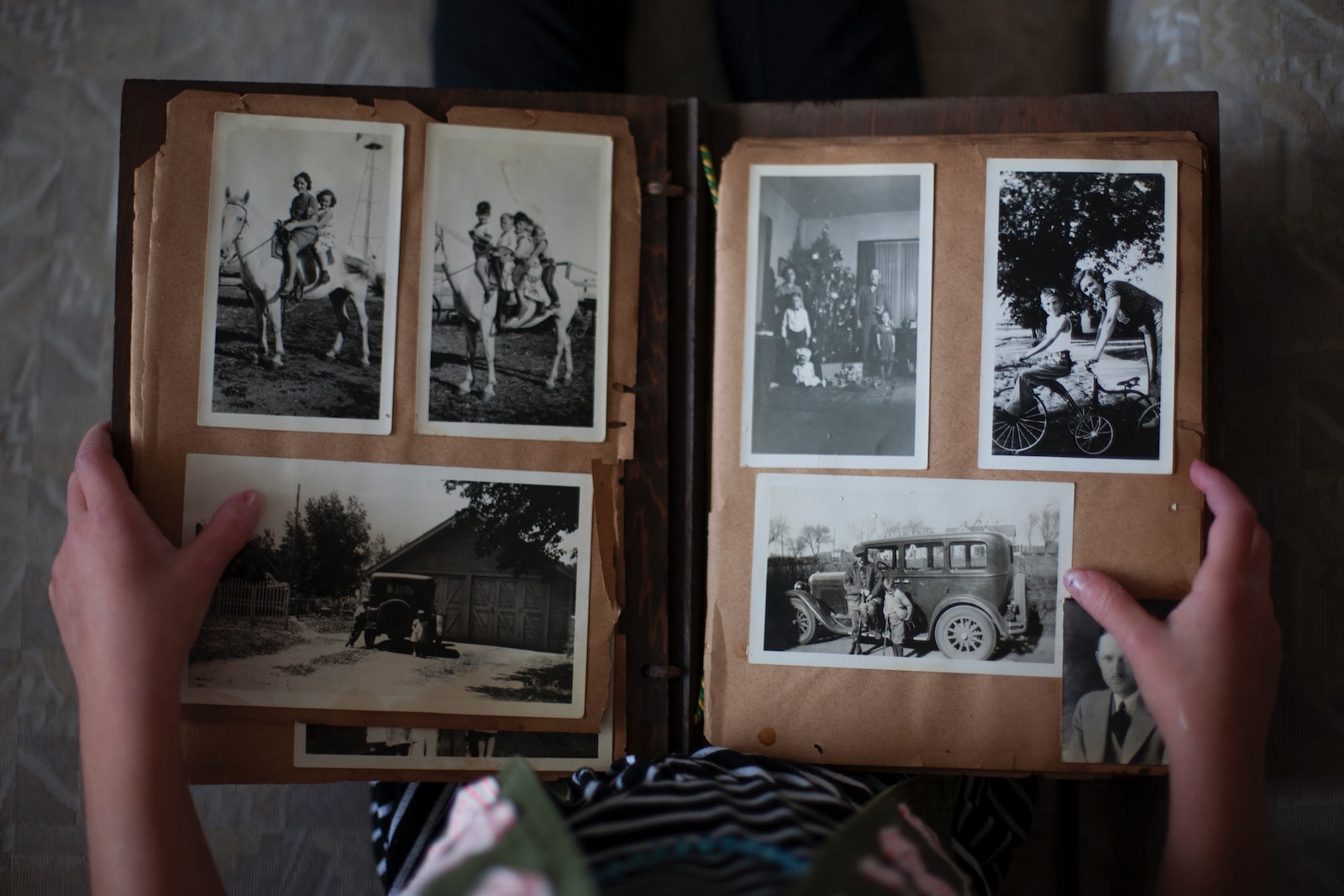 24 class - person opening photo album displaying grayscale photos