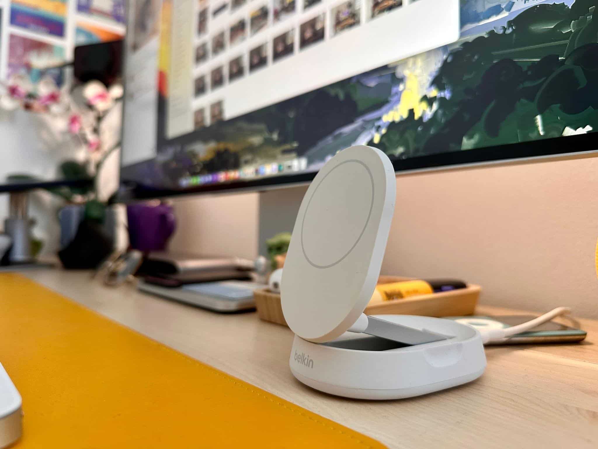 I've settled on this Belkin height-adjustable MagSafe stand, which perfectly fits under the monitor at its lowest height.