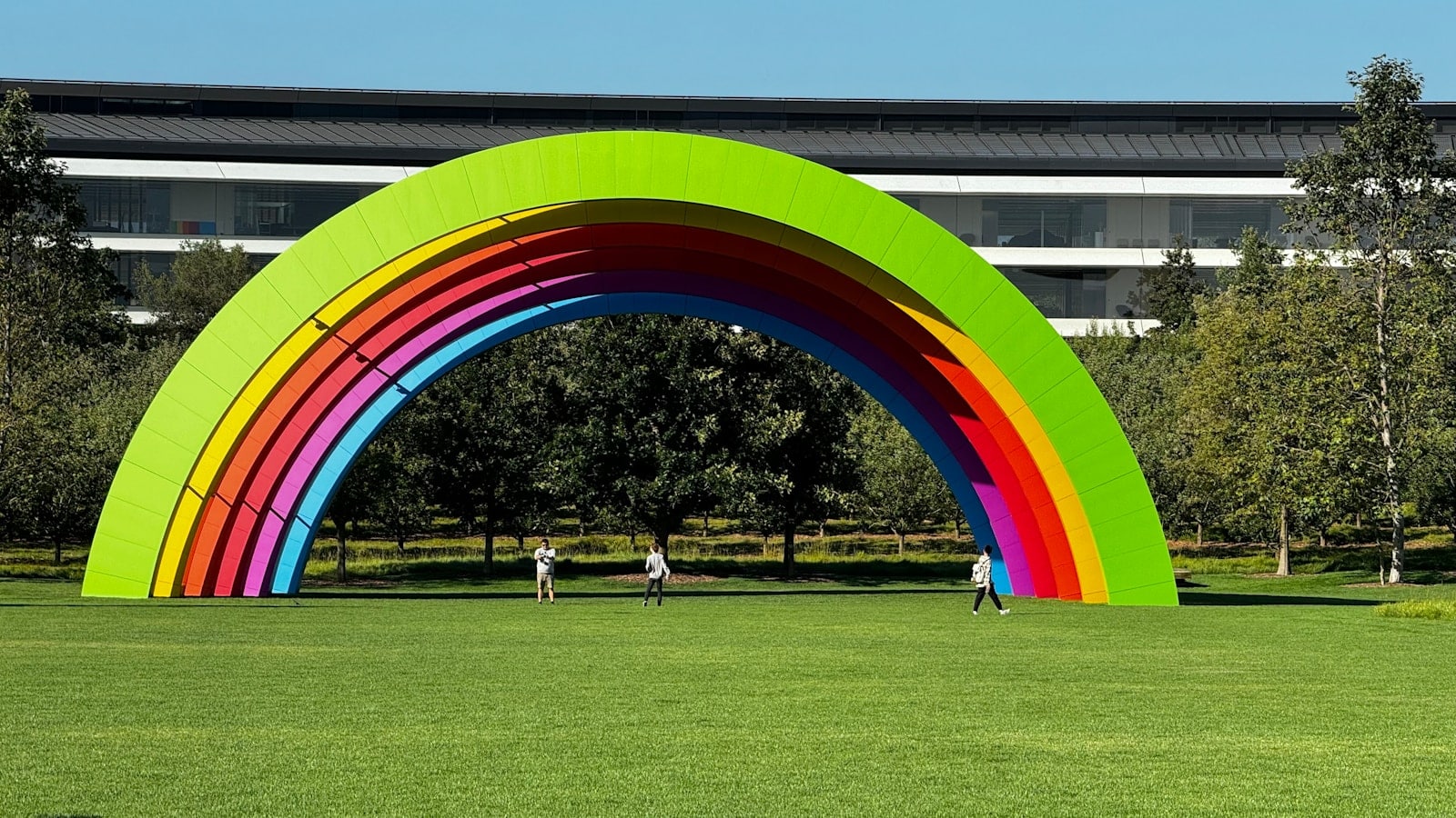 A large green arch with a rainbow painted on it