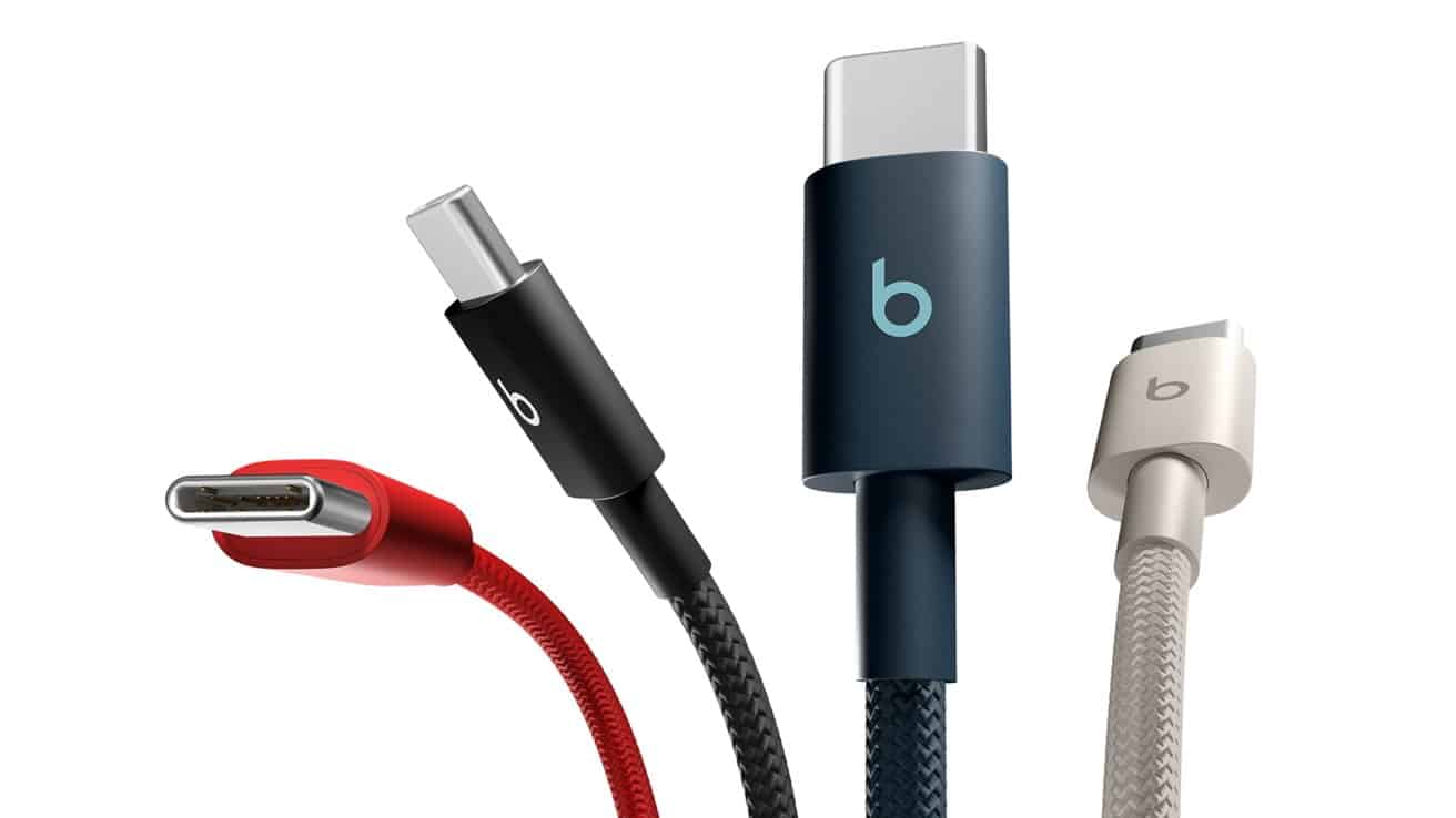 Four USB-C cables in different colors, red, black, navy, and beige, with braided textures, displayed closely together on a white background.