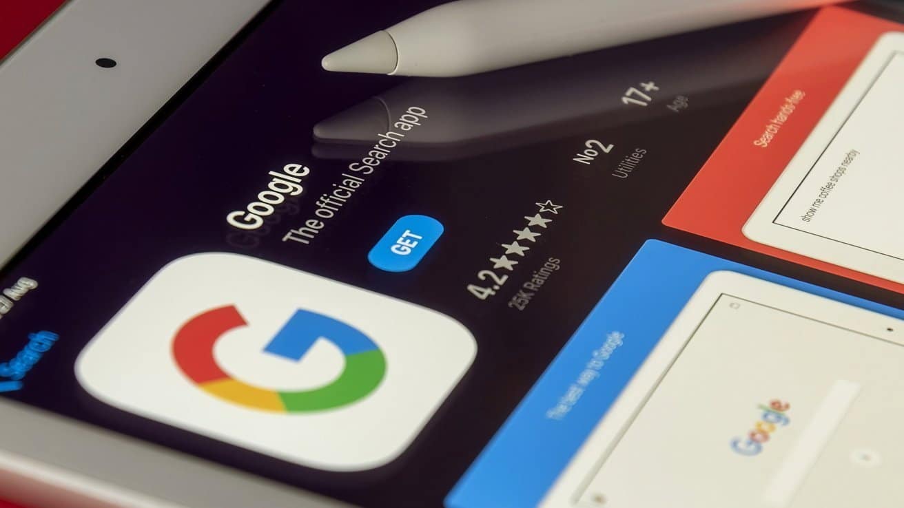 Tablet screen displaying Google app download page with a stylus, showing app rating of 4.2 stars and 'GET' button.