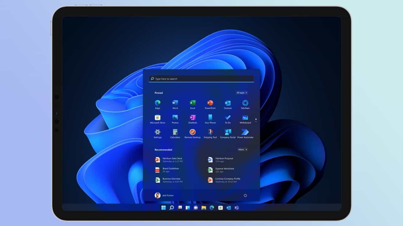 Tablet displaying a Windows operating system with a blue abstract background. The start menu is open, showing various application icons and a search bar.