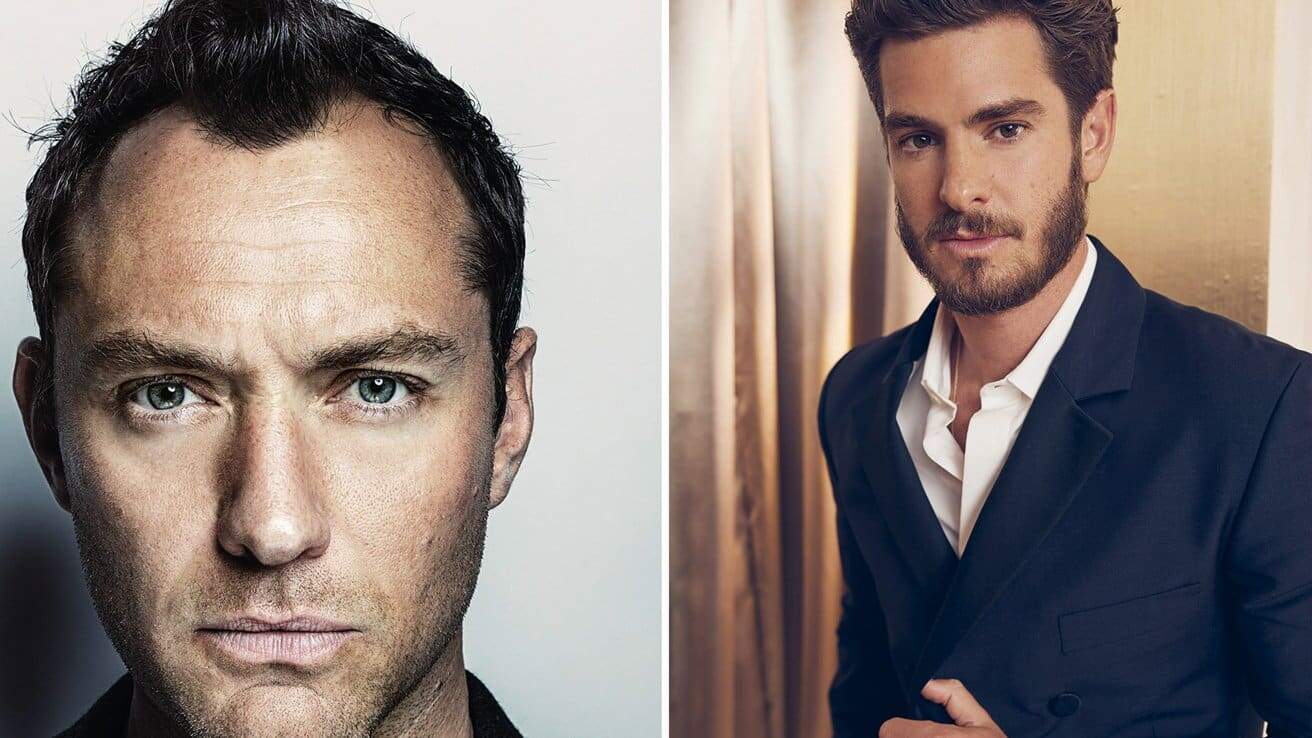 Two men side by side; left man with short dark hair, direct gaze, neutral expression; right man in a suit with beard, light hair, slight smile.