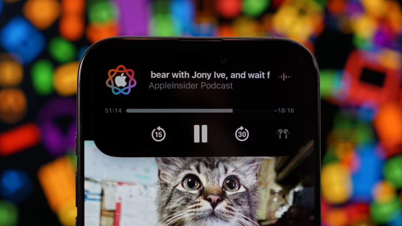 Smartphone screen displaying a podcast titled 'bear with Jony Ive' with a playful cat picture below; colorful blurred background.