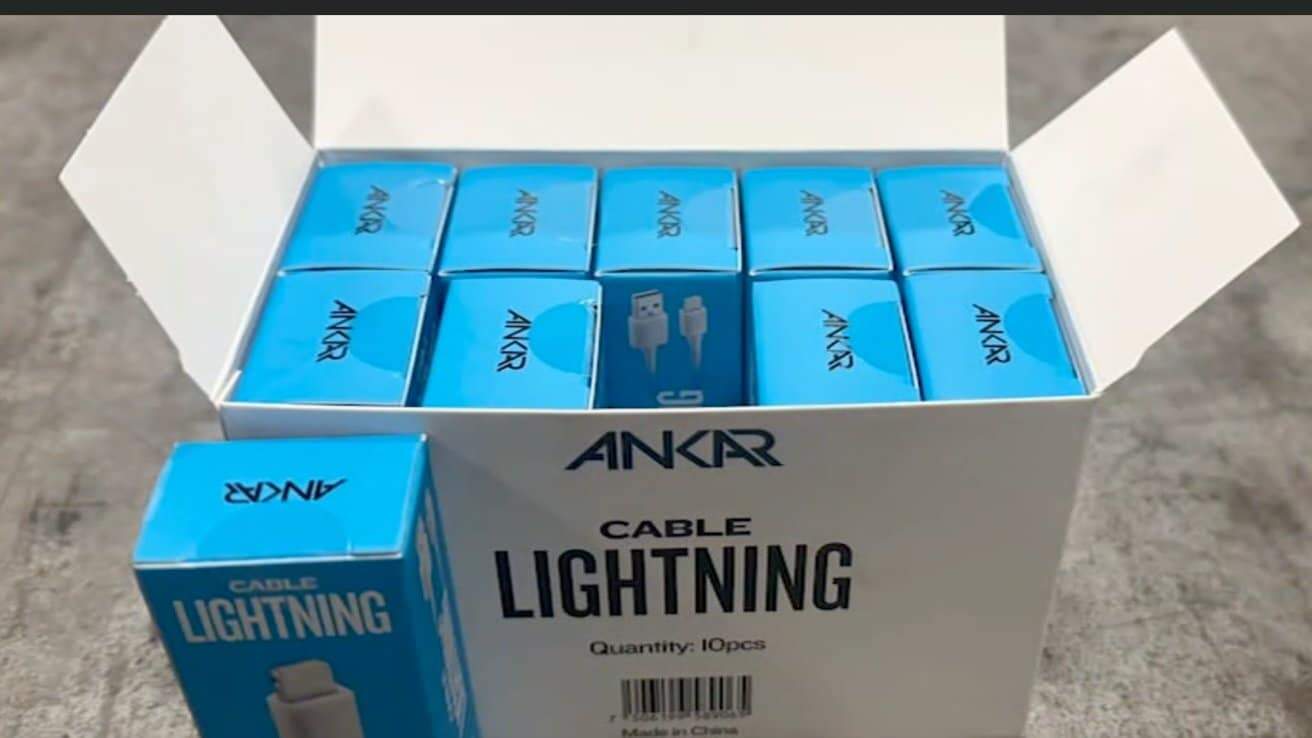 Open box containing blue Ankar lightning cable packages with a total quantity of ten, displayed on a gray surface.