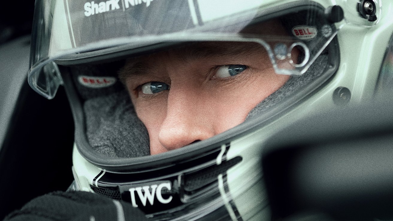 Close-up of a person wearing a racing helmet, their blue eyes looking intently forward with focused expression.
