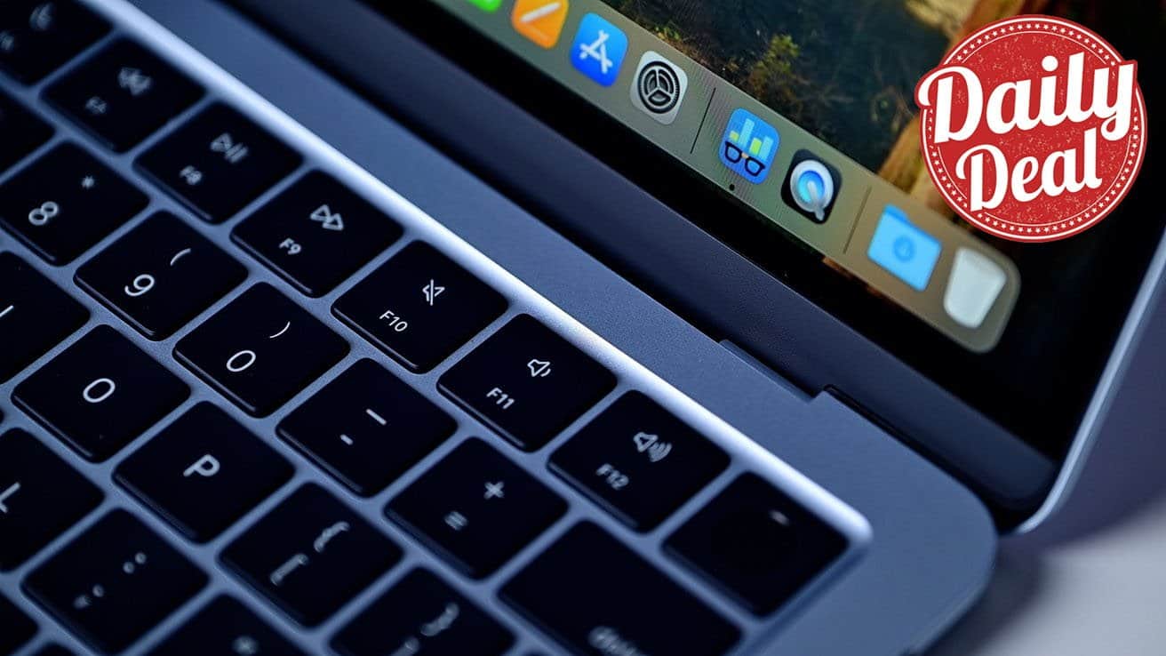 Close-up of a MacBook Air laptop keyboard and screen corner with app icons visible, featuring a red circular 'Daily Deal' badge in the top right corner.