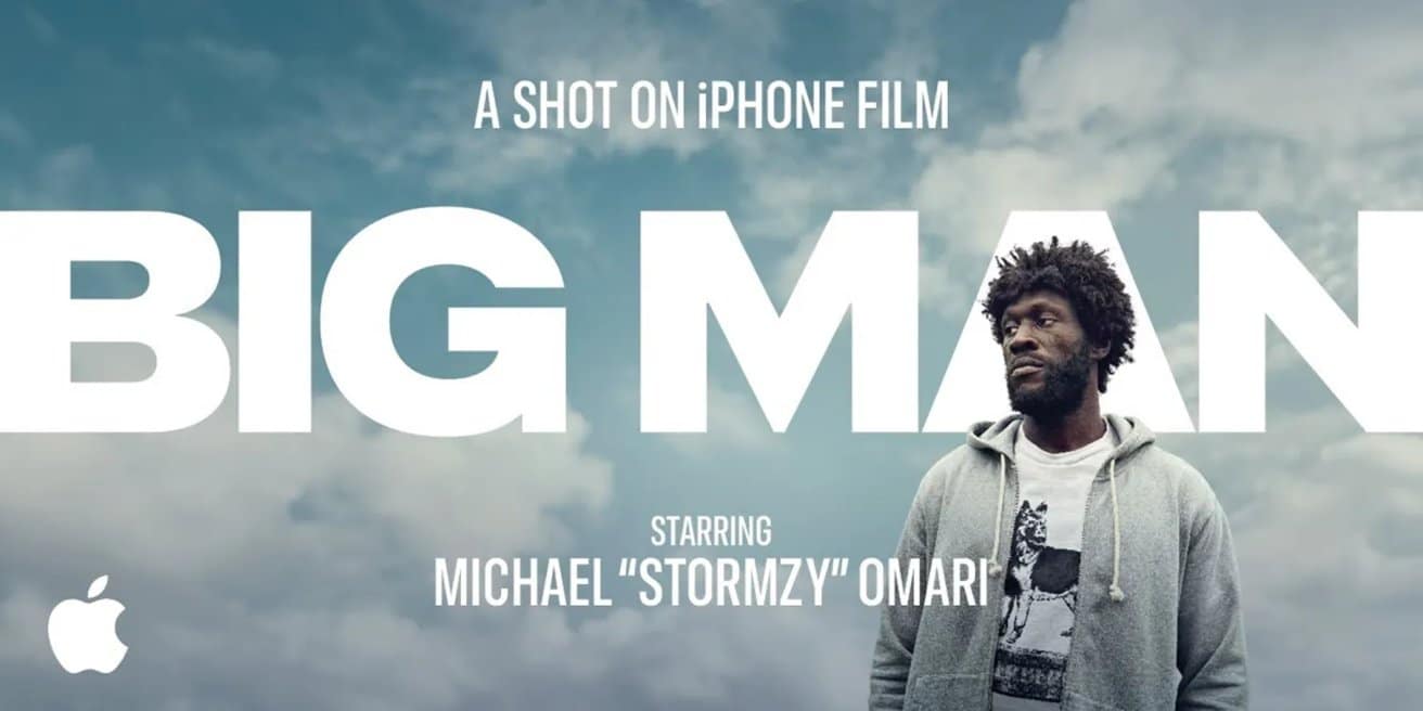 Person in gray hoodie stands against cloudy sky with large text 'BIG MAN.' Top text reads 'A Shot on iPhone Film.' Apple's logo at the bottom left.
