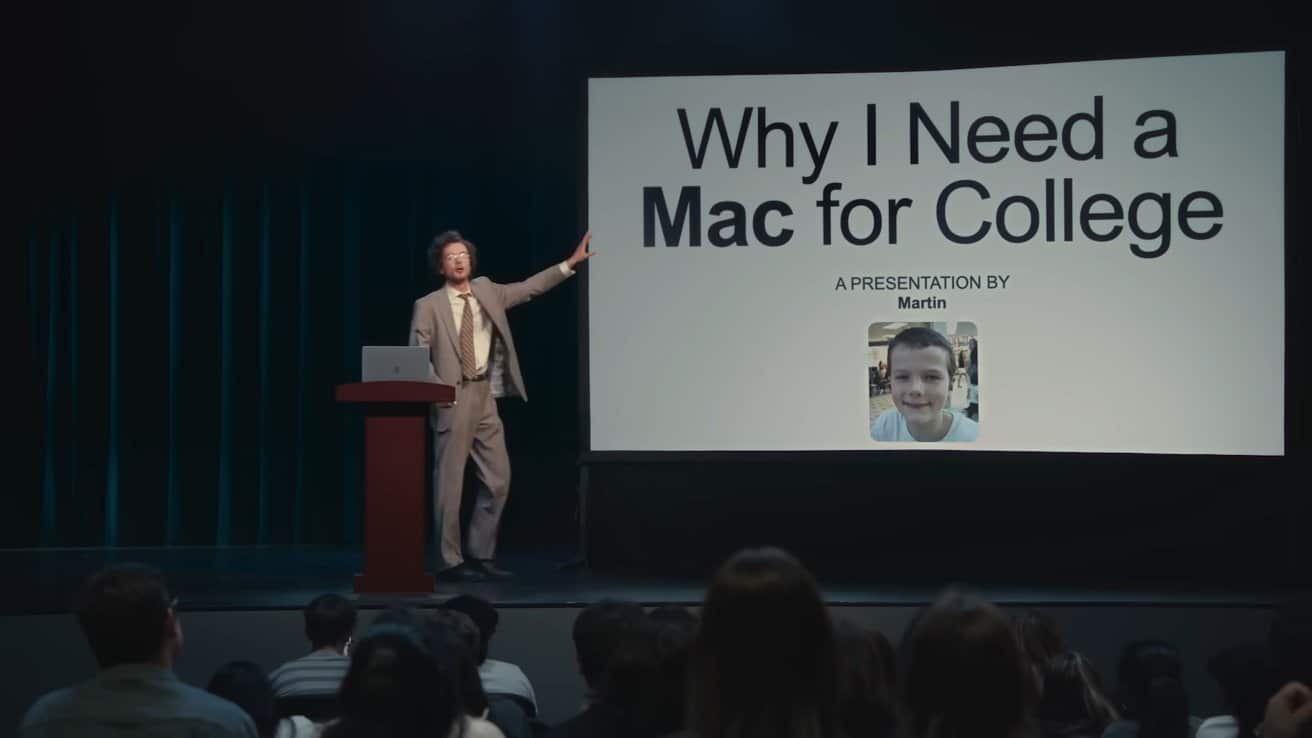 Man in a suit presents 'Why I Need a Mac for College' slideshow to an audience, featuring a child's photo labeled Martin.