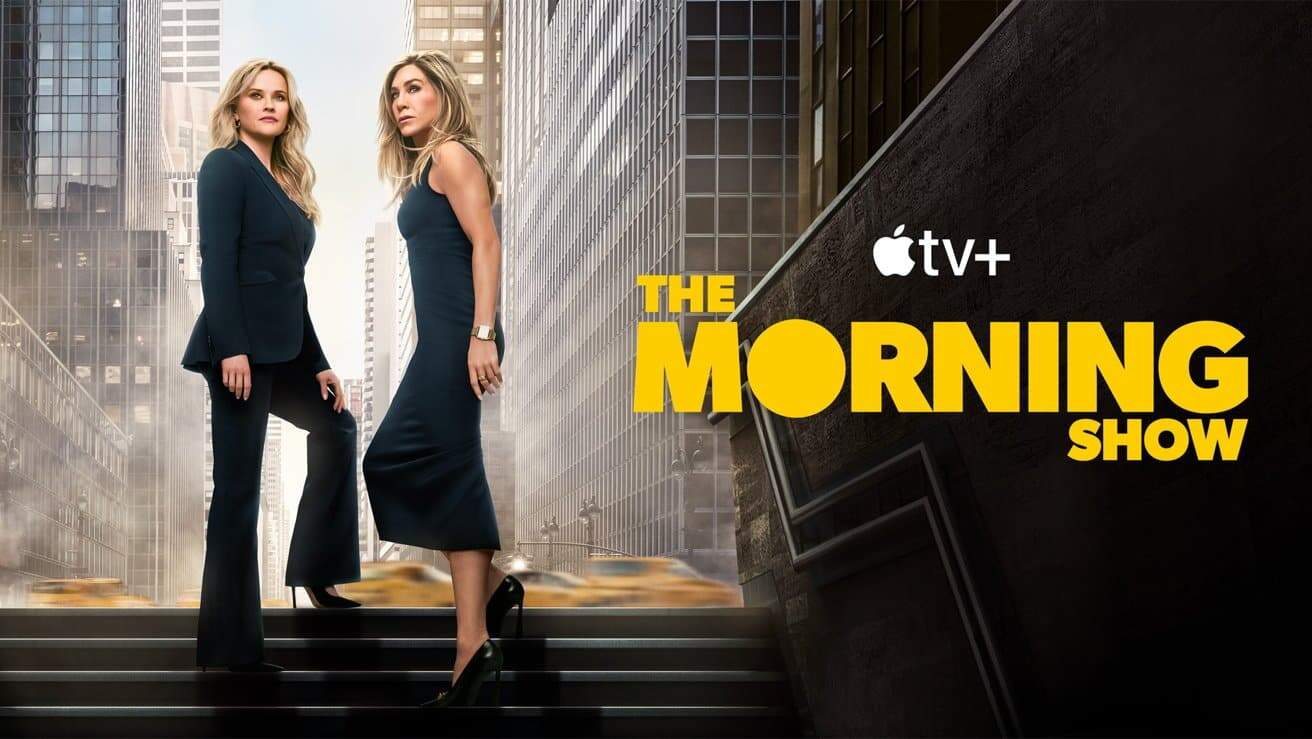 Two women in elegant attire stand confidently on city steps with skyscrapers and yellow taxis in the background, accompanied by 'The Morning Show' title and Apple TV+ logo.