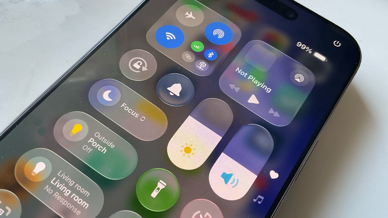 Smartphone screen showing control center with icons for Wi-Fi, brightness, volume, flashlight, focus mode, and notifications, set against a partially visible background.