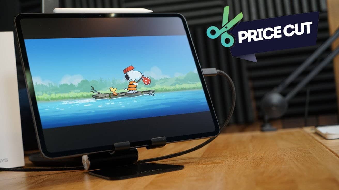 iPad Pro on a wooden stand displaying Snoopy and Woodstock on a log in water, with a 'Price Cut' graphic above.