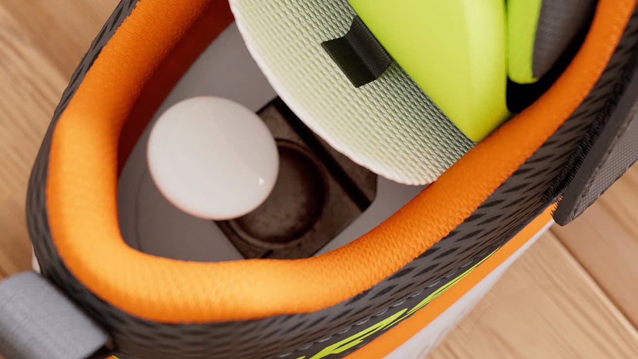 Inside view of a shoe showing orange and gray lining, a white object, and a yellow insert with a black tab.