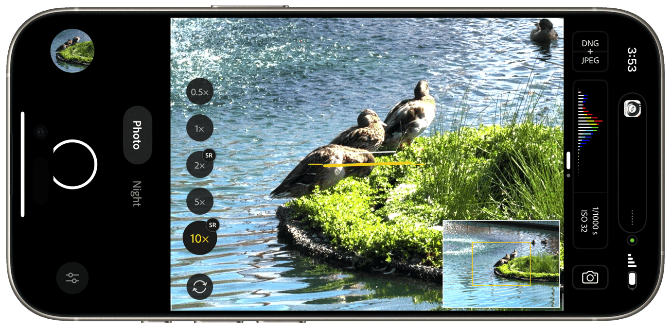 Smartphone screen displaying a photo of ducks on a grassy island in water. Zoom options (0.5x to 10x) and settings (Photo, Night, RAW + JPEG) visible on the sides. A histogram and exposure settings are also shown.