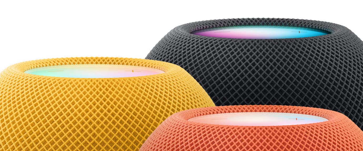 Three smart speakers in yellow, black, and orange with a colorful light ring on top.