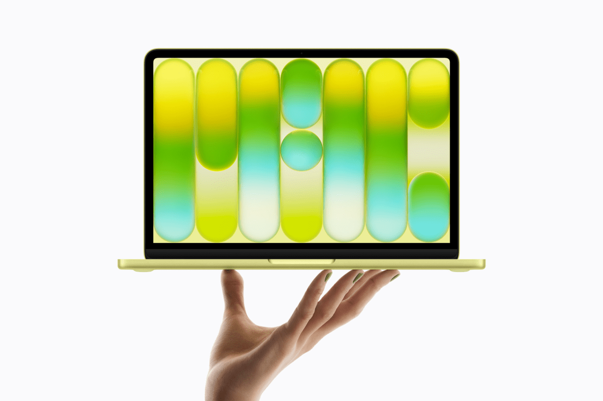 Macbook Neo in yellow in hand